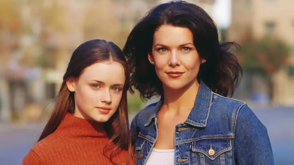 Gilmore Girls Documentary Heading to HBO Max with Lauren Graham and the Palladinos Alexis Bledel as Rory Gilmore and Lauren Graham as Lorelai Gilmore smiling together in a classic promotional portrait for Gilmore Girls.