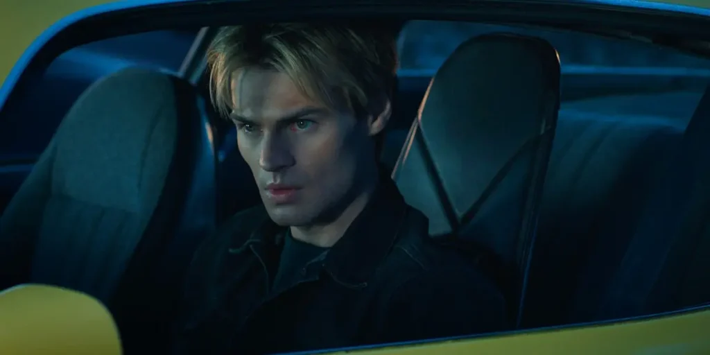 Noah LaLonde as Cole Walter sitting behind the wheel inside a yellow vehicle in My Life With the Walter Boys.