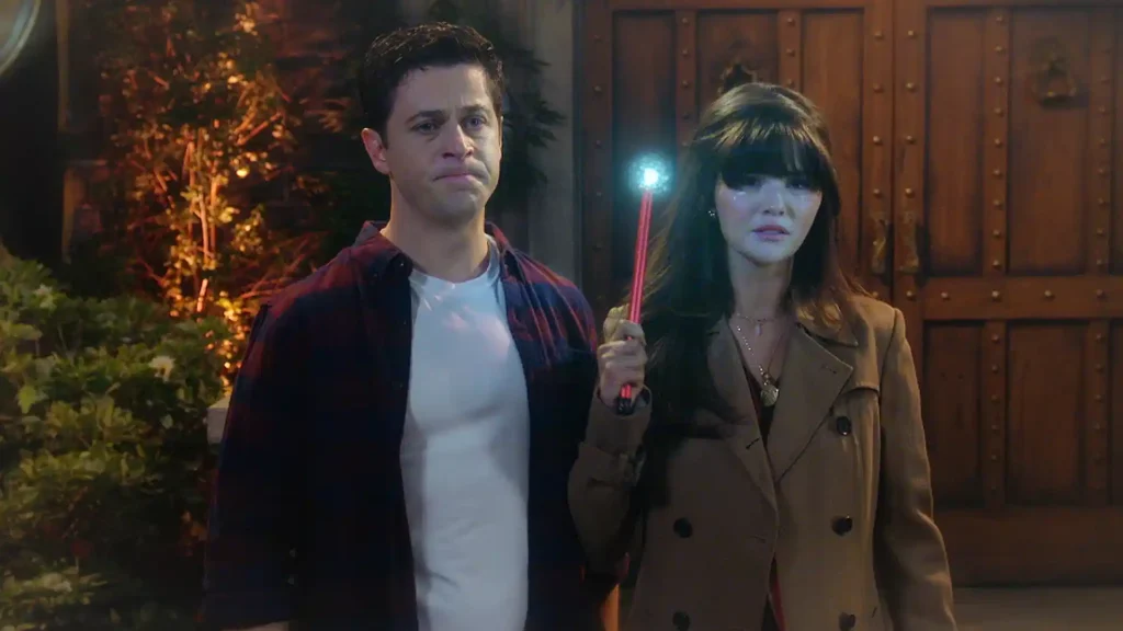 David Henrie as Justin Russo looking emotional alongside Selena Gomez as Alex Russo holding a glowing red wand in Wizards Beyond Waverly Place.