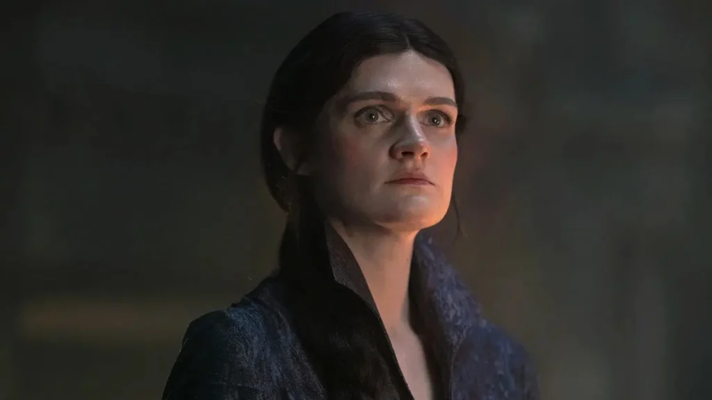 Whose side is Alys Rivers on in House of the Dragon? Gayle Rankin as Alys Rivers bathed in warm firelight looking upward in House of the Dragon.