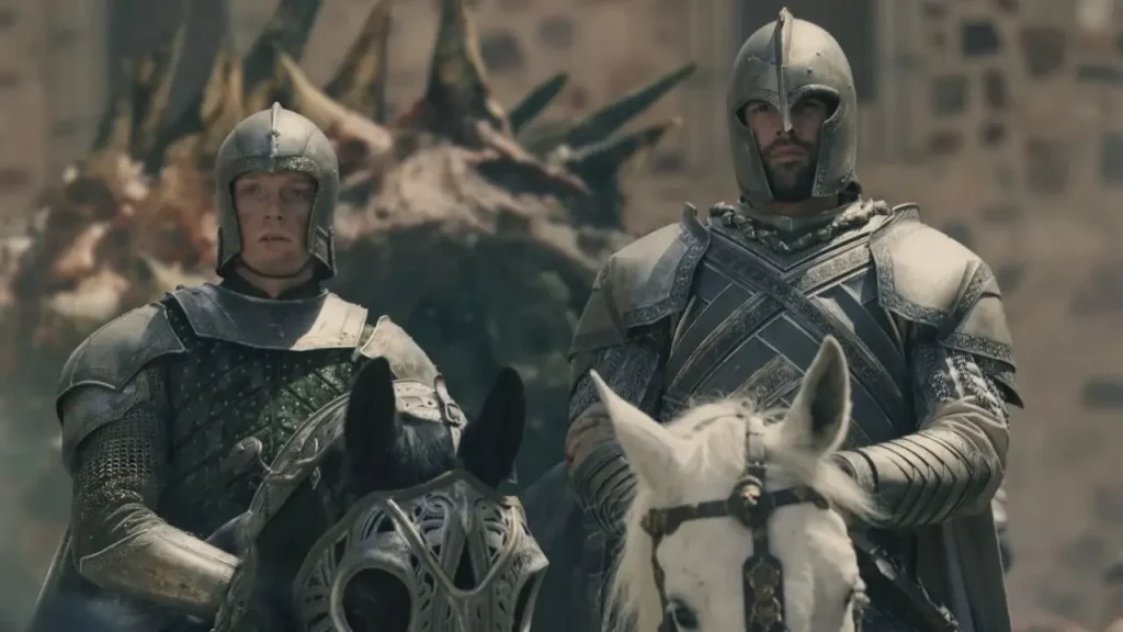Ser Gwayne Hightower and Ser Criston Cole mounted on armored horses in full steel suits of armor, with a dragon's head visible in the background, in House of the Dragon.