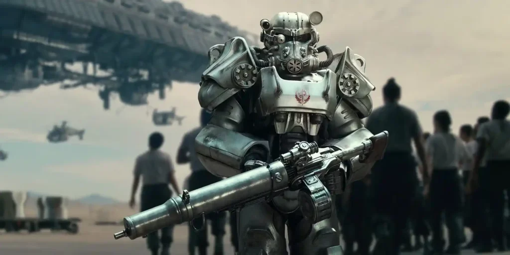 A soldier wearing T-60 Power Armor holding a heavy assault rifle in a scene from Fallout.