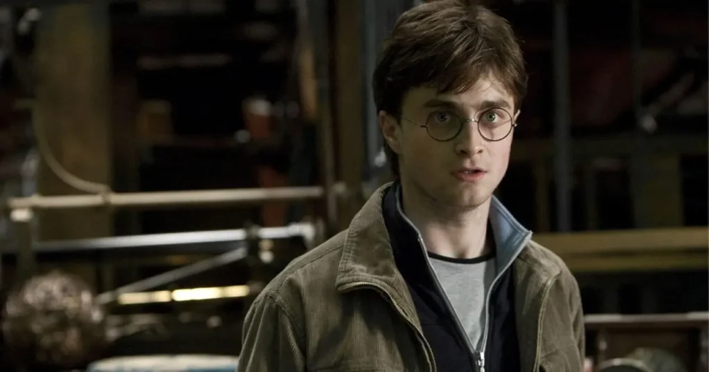 Why HBO’s Harry Potter Series Has the Ultimate Opportunity to Evolve the Boy Who Lived Daniel Radcliffe as Harry Potter wearing glasses and a brown jacket with a surprised expression in Harry Potter and the Half-Blood Prince.