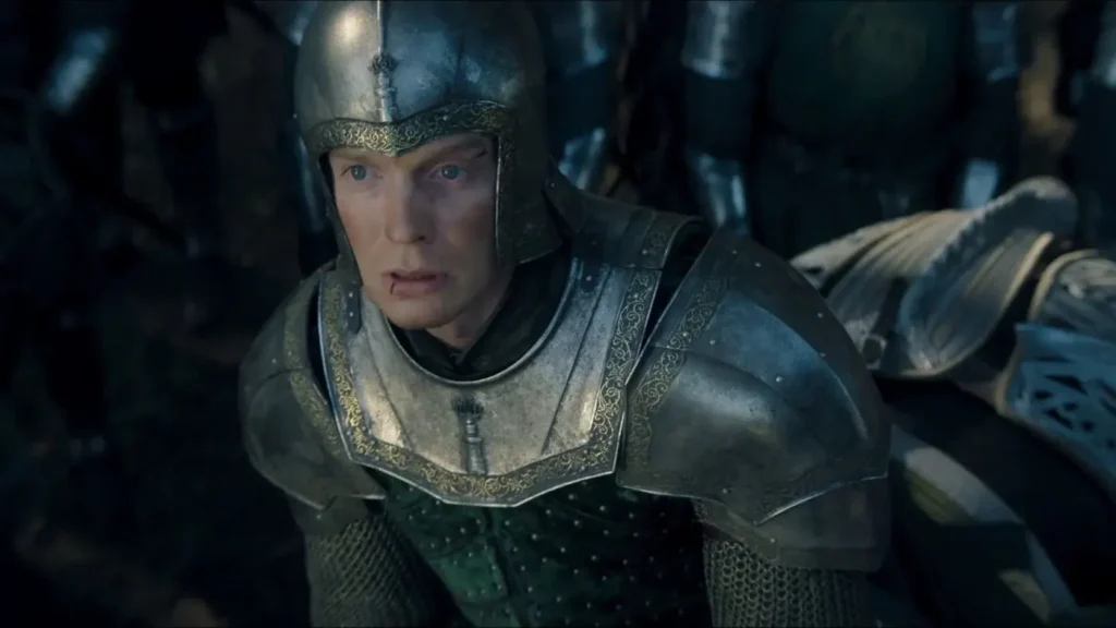 Ser Gwayne Hightower wearing steel armor with ornate trim, looking upward with a stunned, fearful expression in House of the Dragon.
