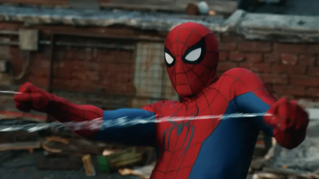 Spider-Man: Brand New Day – The Three Scenes That Had Audiences Applauding in Theaters Spider-Man in a red and blue suit pulling on web lines against an urban brick background.
