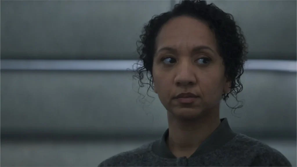 Close-up of Remmie Akiuele looking sideways with a concerned expression in Silo.