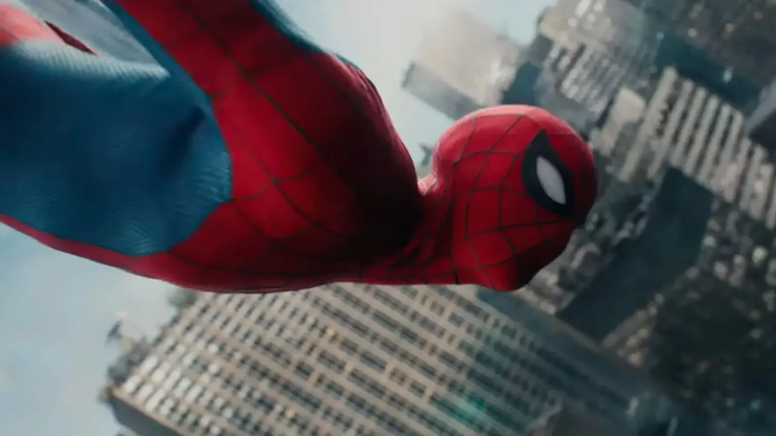Spider-Man in his classic red and blue suit diving headfirst through the air above New York City skyscrapers in a dynamic side-angle shot.