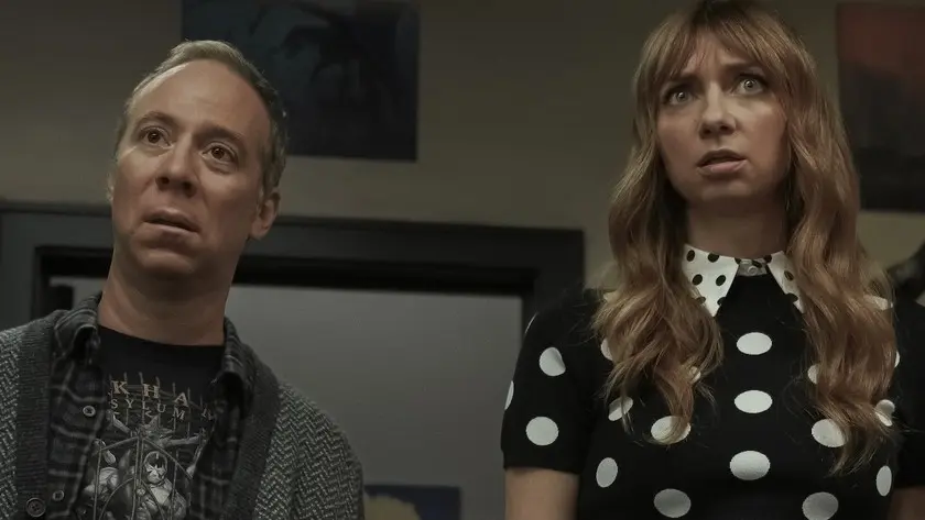 Kevin Sussman and Lauren Lapkus looking up with wide, shocked expressions.