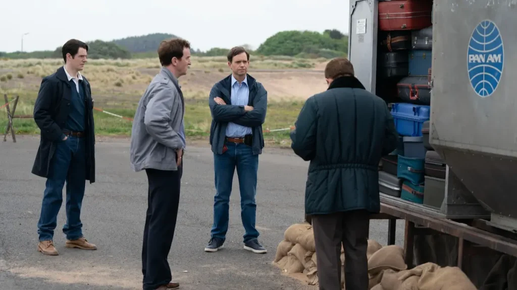 The Bombing of Pan Am 103 Review: A Thoughtful Drama That Refuses to Turn Tragedy Into Entertainment Investigators gathered around an open Pan Am luggage container filled with suitcases in Netflix's The Bombing of Pan Am 103.